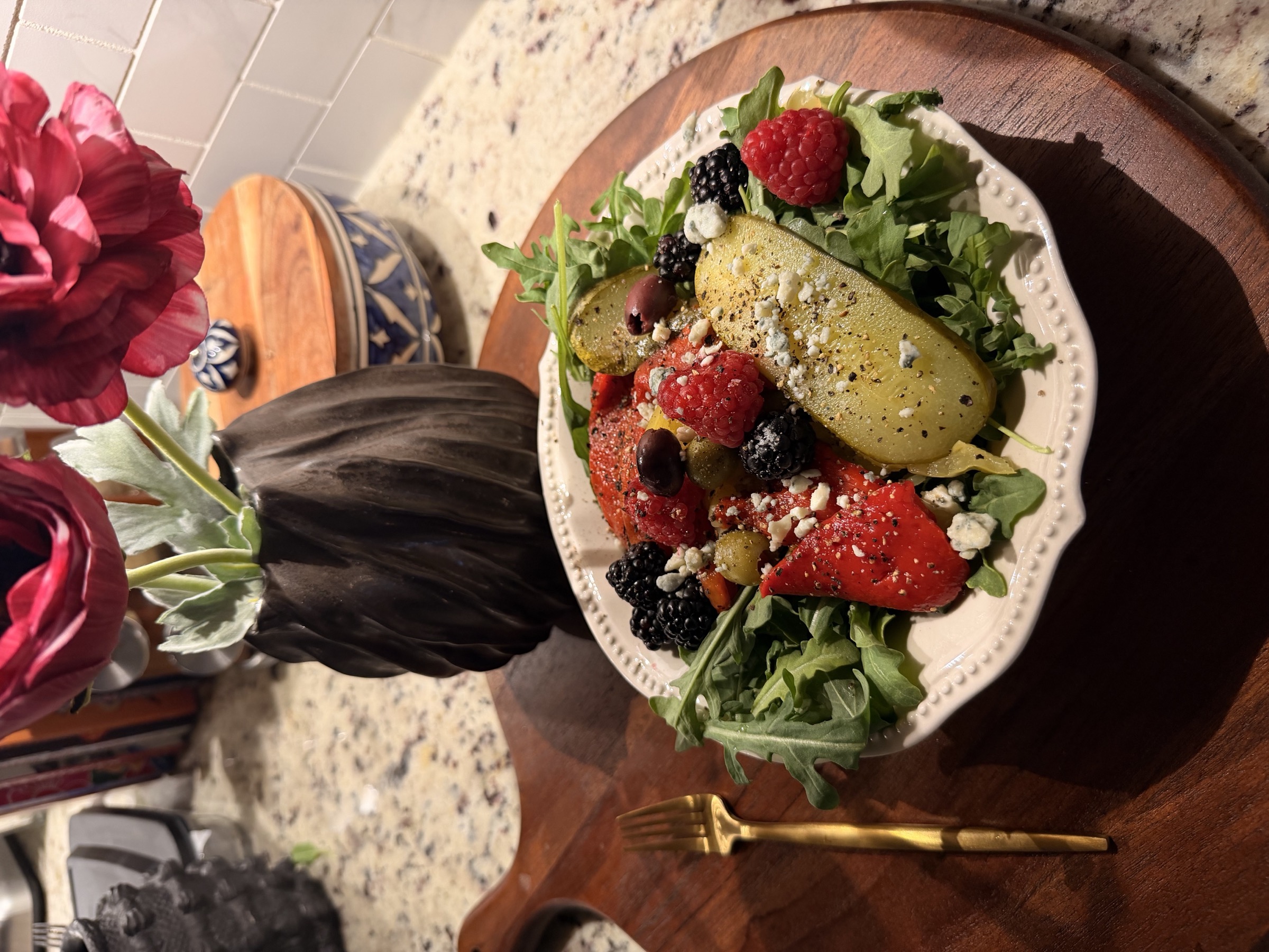 Refeeding plate: arugula and berry salad with olives and gold fork